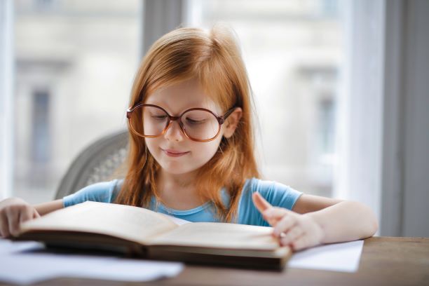 Canva – Girl in Blue Shirt Wearing Eyeglasses Reading Book